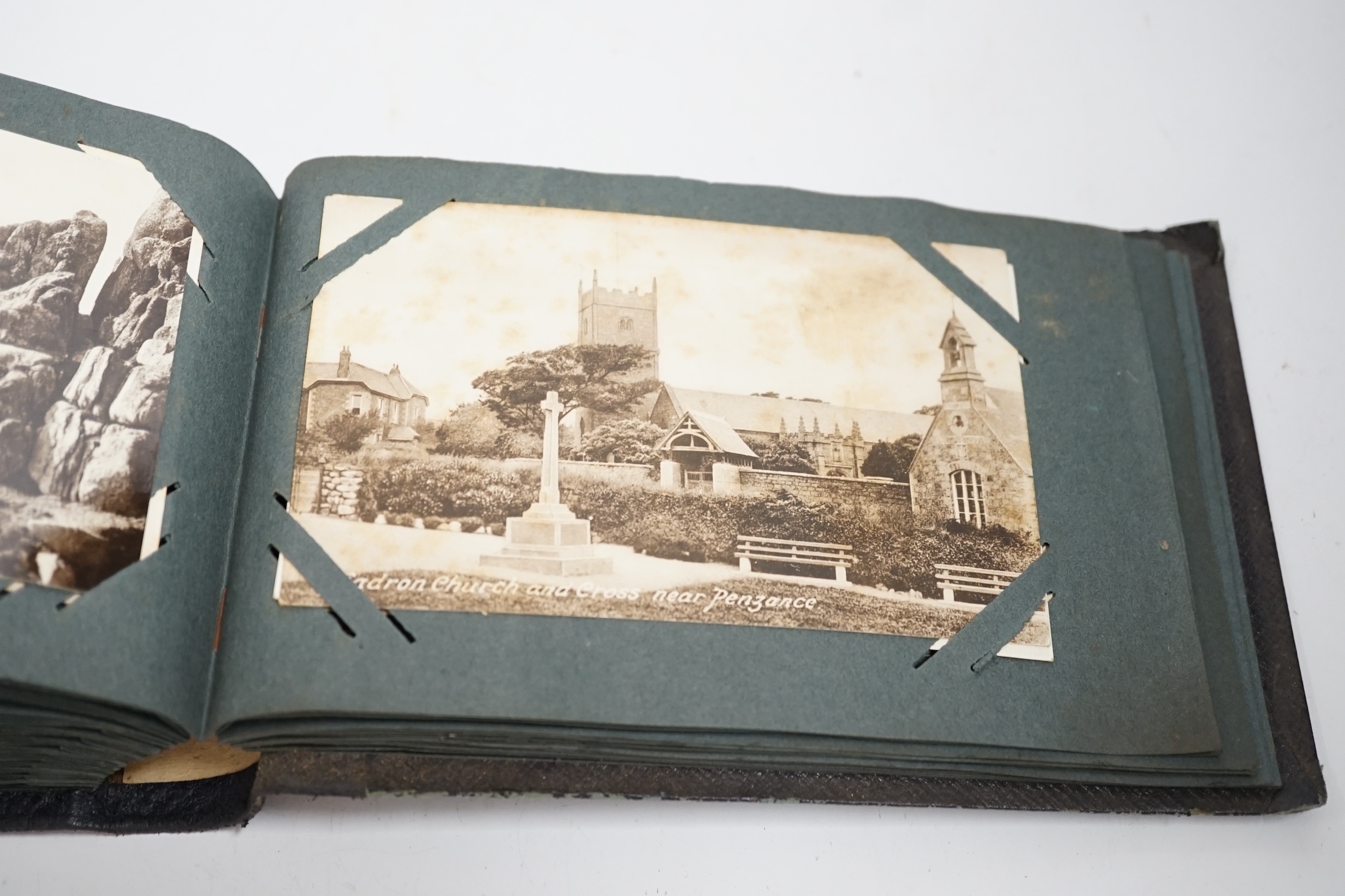 Three postcard albums, topographical examples including the Isle of Wight